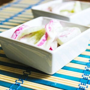 Sour Cream Cucumber Salad in white bowl.